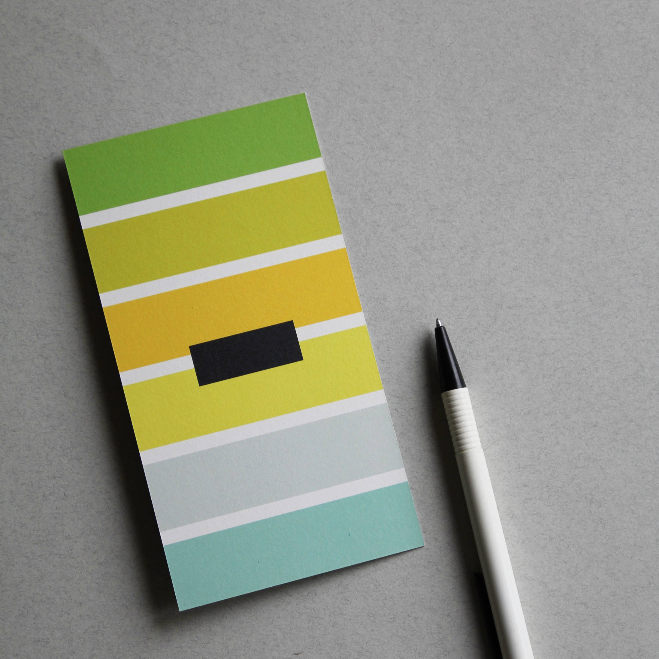 Postkarte bunt gestreift mit dem Sonderzeichen „-“ (minus)